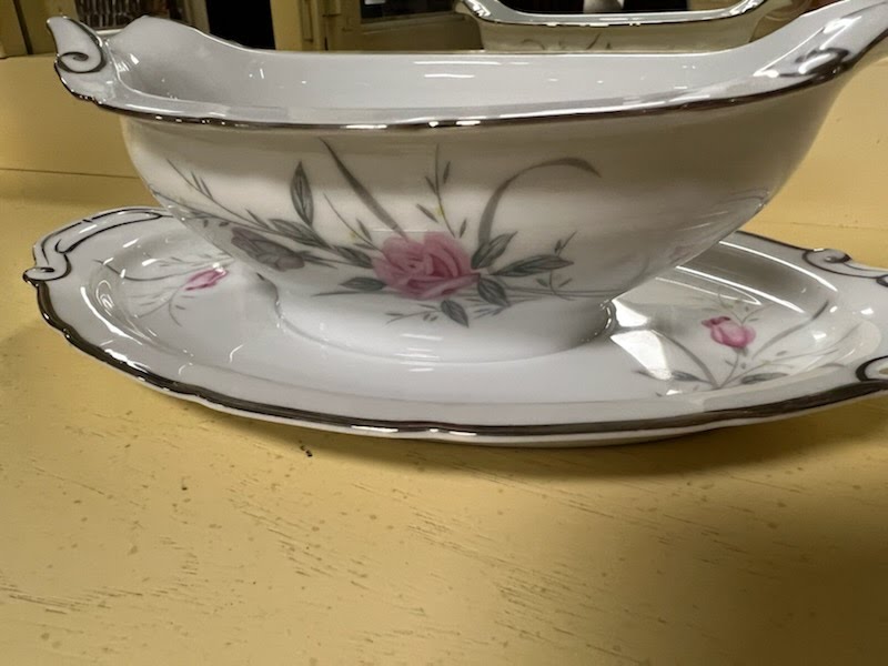 Gravy boat with attached plate