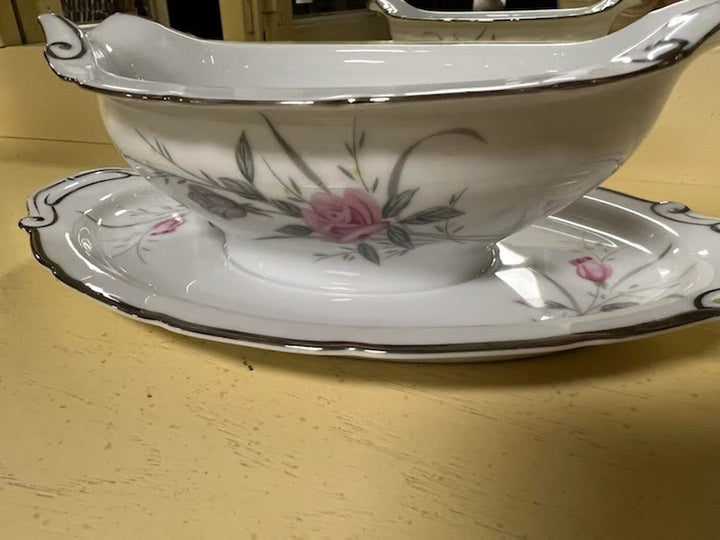 Gravy boat with attached plate