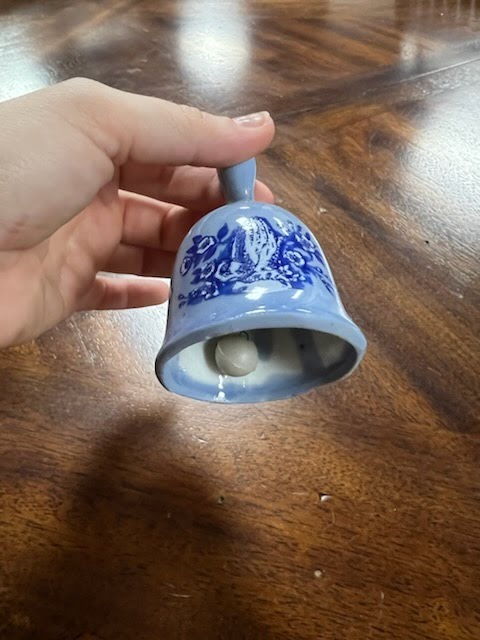 Blue hand bell with prayer hand design